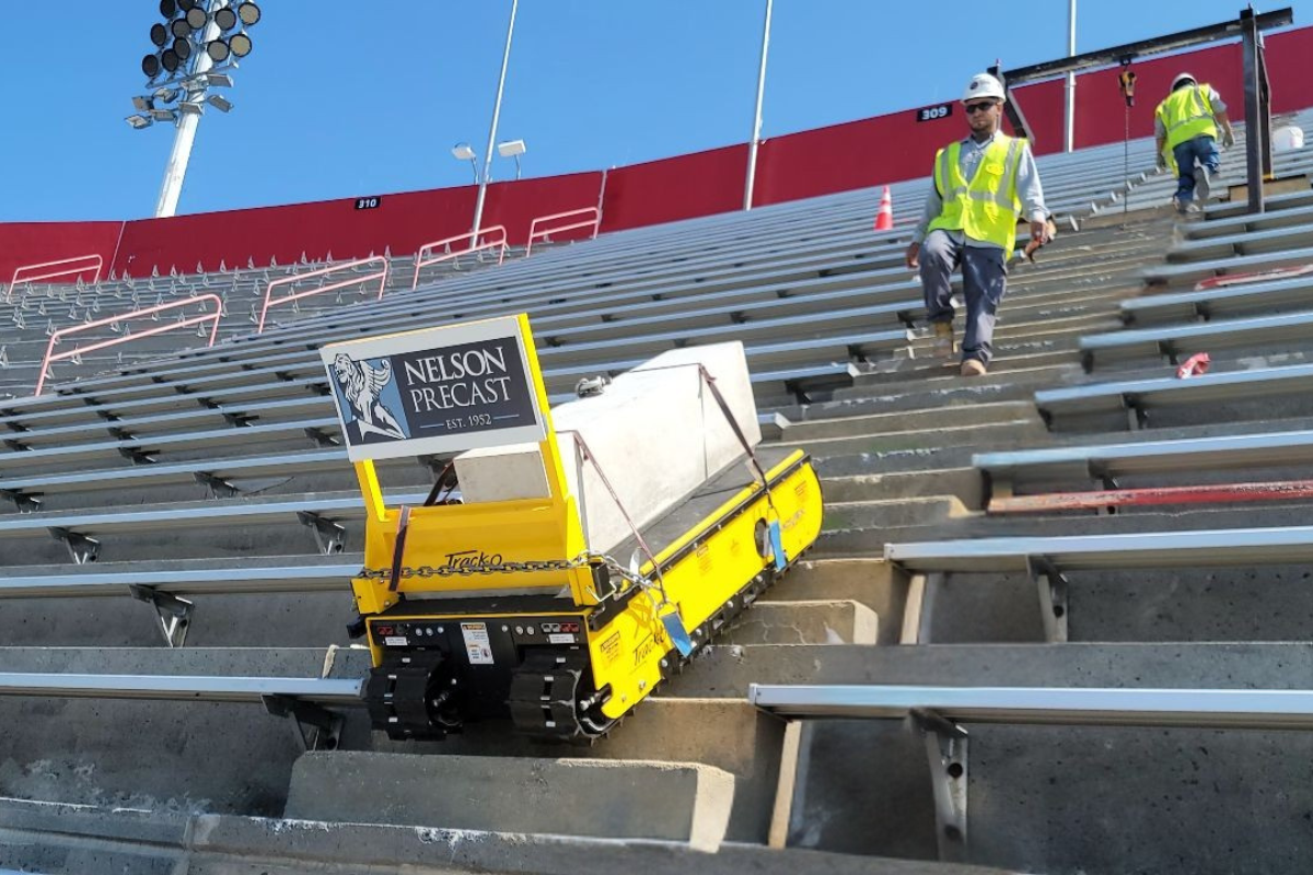 Stair climber moving concrete block in a stadium