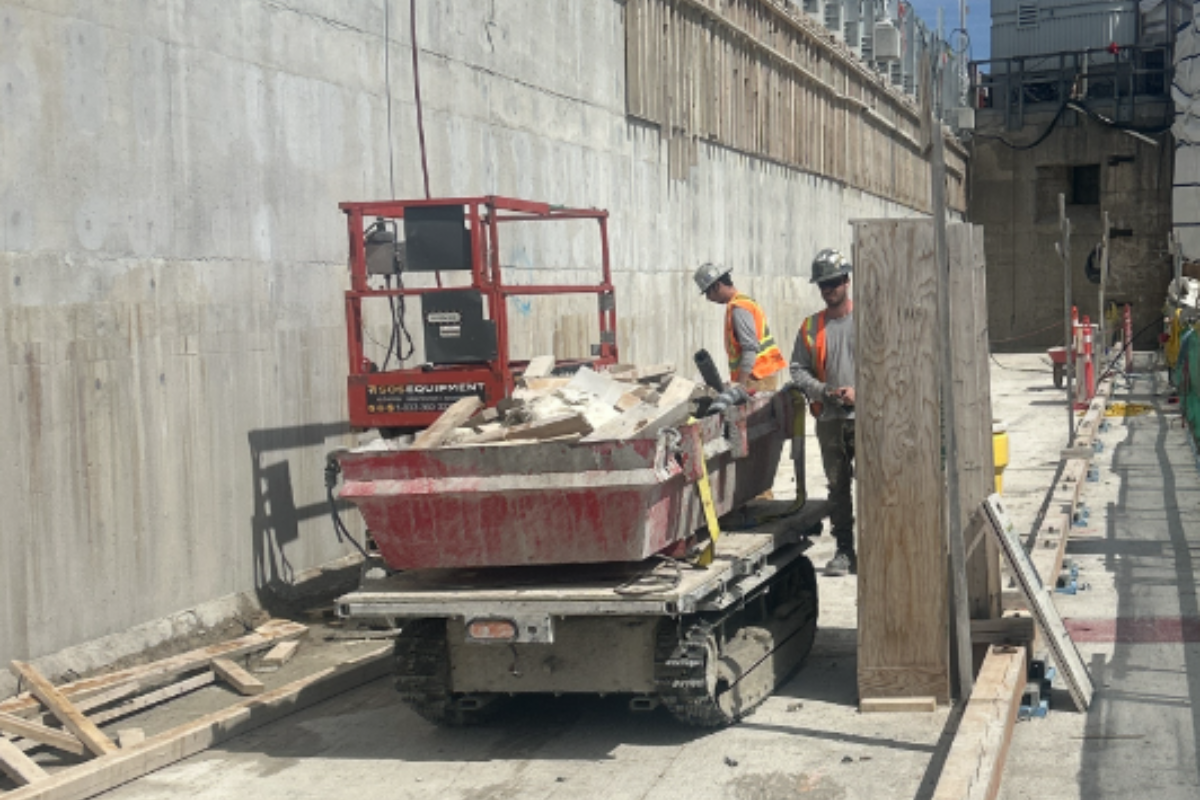 All-Terrain carrier moving construction material on a dam