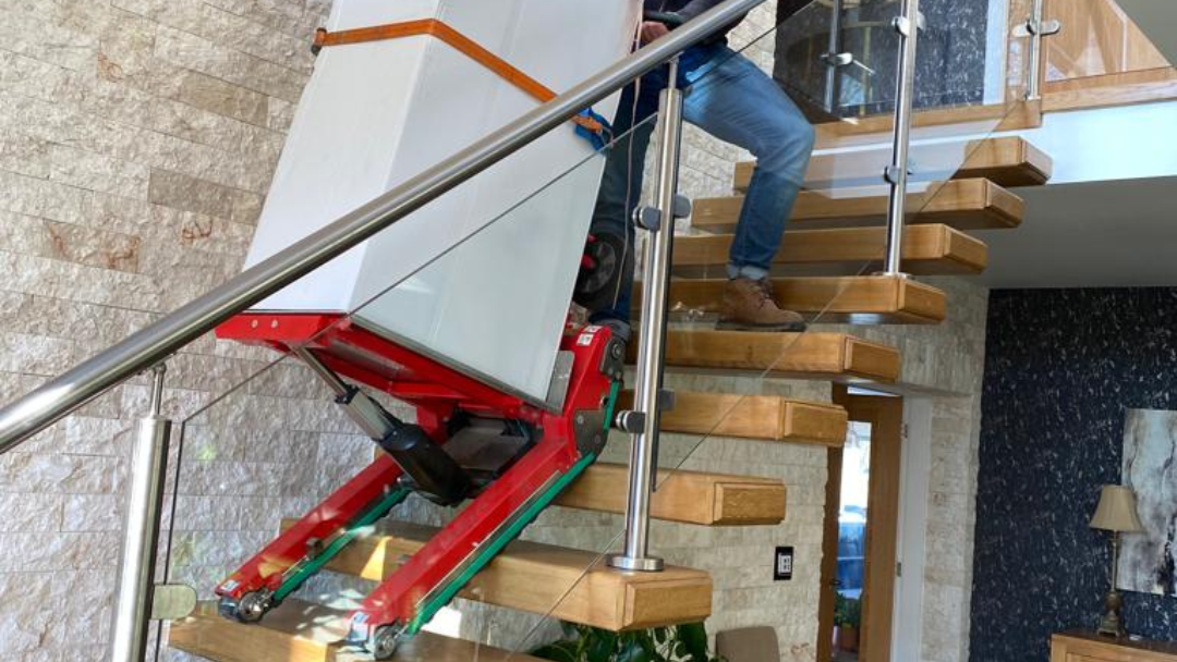 Transporting a HVA up stairs with the Domino Stair climbing robot