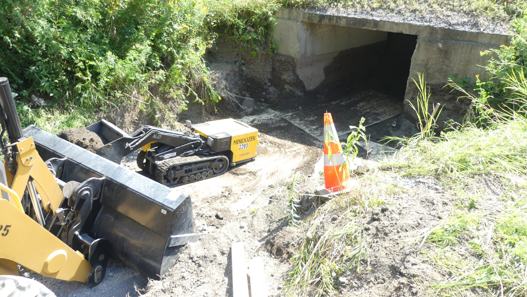 MINIDOZER removing spillage in a box culvert